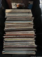 Front view of full stack of vinyl records in crate