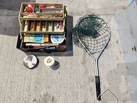 Lot overview showing tackle box, landing net, loose spools on concrete