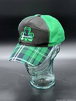 Front left view showing shamrock embroidery, plaid brim, crown color contrast