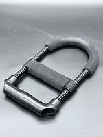 overall view of strengthener showing springs, foam grips and handle