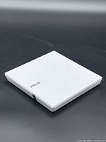 Top view of white ASUS external optical drive