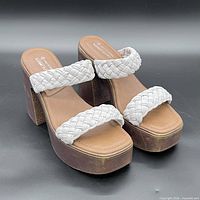 Front angle view of both heels showing braided straps, footbeds and overall design