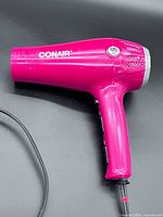 Left side view of hair dryer showing Conair logo and overall condition