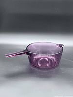 Side view of cranberry Corning Visions glass 2.5 L saucepan with handle