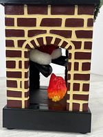 Front view showing brick fireplace, Santa legs, internal flame