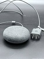 Google Home Mini with adapter and cable, top fabric view