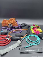 Assorted resistance bands, ankle weights and straps displayed