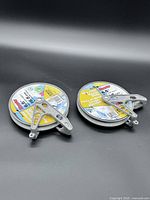 Two metal pulleys side by side, labels visible