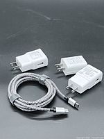 overview of three white power adapters and braided USB-C cable