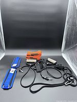 Entire lot overview showing blue ankle straps, orange loop bands, black tube, rope and strap