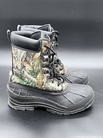 Side profile of both boots showing camouflage uppers and rubber lower shell