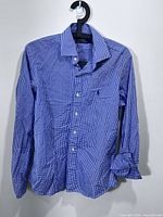 Full front view of blue and white gingham Polo Ralph Lauren long-sleeve shirt on hanger