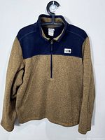 Front view of The North Face brown and navy half-zip sweater