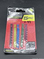 Front of sealed Tooltech Workbench 5-piece jigsaw blades pack showing all blades and price sticker
