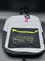 Front view of backpack showing stripes, front pocket logo, zipper