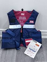 Front view of navy/pink Helly Hansen life vest with tags attached