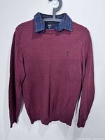 Full front view of maroon knit sweater with plaid collar