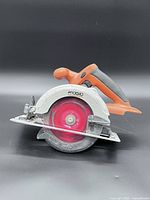 Left side profile showing blade guard and overall body