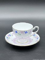 Teacup on saucer showing floral pattern and gilt trim