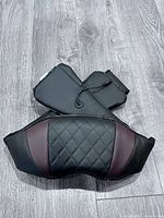 Front view of massager showing quilted exterior and arm straps