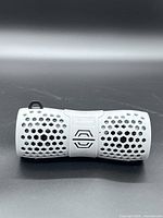 Front view of gray Sylvania SP332 speaker showing honeycomb grille and logo