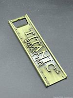 Front view of metal magnetic Titanic Belfast 1912 bottle opener