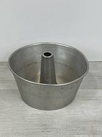 Top view of aluminum tube cake pan showing central cone and interior condition