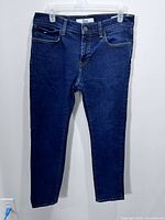 Full front view of jeans on hanger