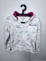 Front view of white Harry Potter themed hoodie on hanger