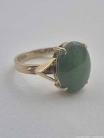 Side view showing 14K gold band and prong-set green jade cabochon