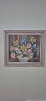 Full view of framed floral oil painting on wall