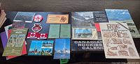 Overview of postcards, brochures, patches, pin and calendar laid on table