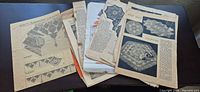 Stack of assorted vintage German pattern sheets on table