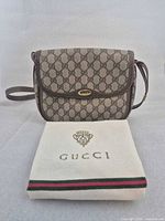 Front view of Gucci GG monogram crossbody bag with dust bag
