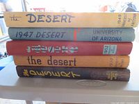 Stack of five yearbooks showing spines with years 1947, 1949-1952