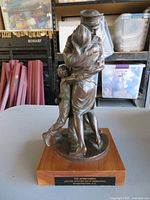 Front view showing full sculpture, base and plaque