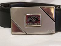 Close-up of AX buckle on black leather belt