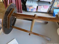 underside view showing tripod legs, stretcher, construction