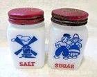 Front view of both milk glass shakers showing graphics and lettering