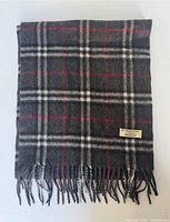 Full scarf folded showing plaid pattern and fringe