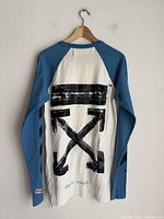 Back view showing cross-arrows graphic and colour blocking