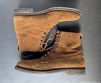 Side view of both boots showing suede, laces, heel