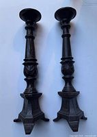 Full view of both cast iron candle holders