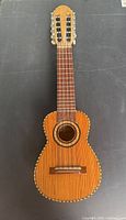 Front view showing full charango, soundboard, rosette, rope binding, 10 strings