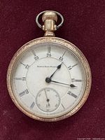 Front view of Elgin pocket watch showing dial, hands and sub-seconds
