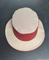 Top angle of beige and red cotton bucket hat