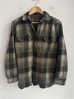 Front view of plaid shirt on hanger
