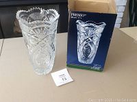 Premio crystal style vase standing next to its original box on table with instruction sheet visible.