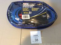 Booster cables packaged in blue zippered clear plastic bag with NASCAR Advantage branding, cables visible inside, blue insulated wire and clamps.