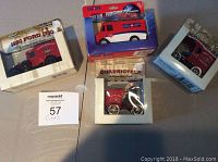 Eight collectible die cast cars shown with original packaging on a table.